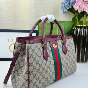 Alternative view of Batch 340... The new Ophidia collection presents striking silhouettes and functionality, expertly crafted in signature beige and brown colorways to create soft-textured, refreshed bag styles.Beige and dark brown GG canvas Brown leather trim Light gold-tone hardware Green cotton lining Interior: One open pocket, one zippered pocket in center divider Handles (10 cm high) Removable and adjustable leather shoulder strap (Height: 50 cm to 55 cm;Length: 108 cm to 118 cm) Model: 836839 Dimensions: 33.5 cm (W) x 25 cm (H) x 14 cm (D) Weight: Approx. 0.95 kg Color: Brown/Red PVC. Made in Italy