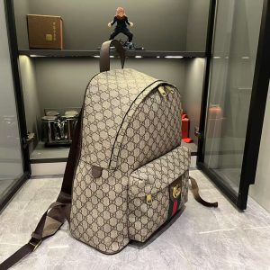 Alternative view of Batch 380...GG Ophidia series masterfully blends two shades of black, pairing classic silhouettes with new functionality, crafted from exceptionally soft fabrics. This backpack features GG monogrammed coated fabric, meticulously embellished with double G logos and red-green woven ribbon details.Gold-tone hardware. Dark green linen-cotton blend lining. Model: 834466. Dimensions: 36.5 x 41 x 18 cm.