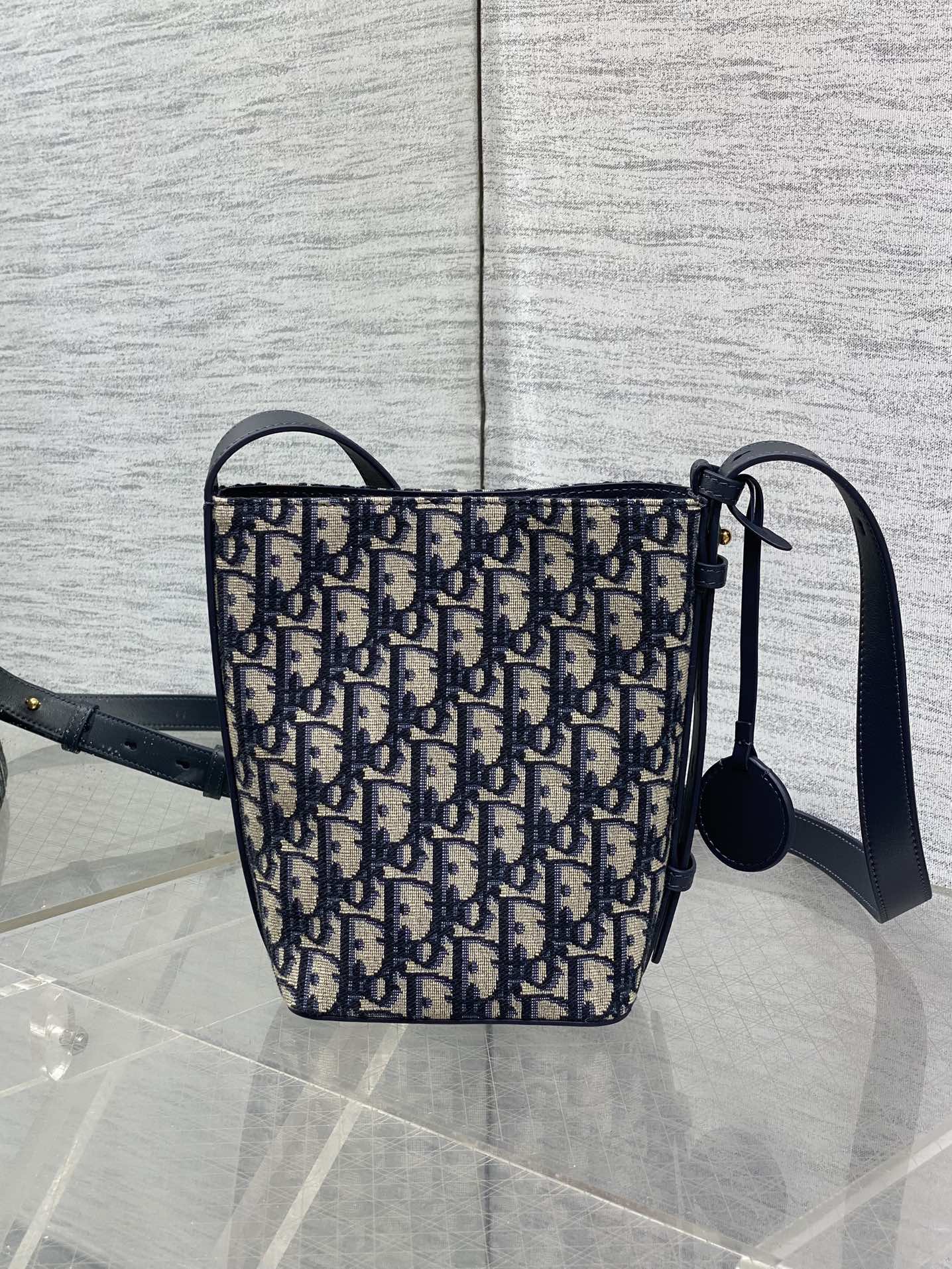 In Stock‼️ Dior's New Star Bucket Bag Collection The latest stunning handbags have arrived! Crafted from classic Oblique monogram fabric with exquisite workmanship, this adorable bucket bag design blends elegance with modern style. Its soft silhouette features a drawstring closure and removable long shoulder strap, combining practicality with beauty. Perfect for holiday outings—carry it with flair wherever you go! - Image 3