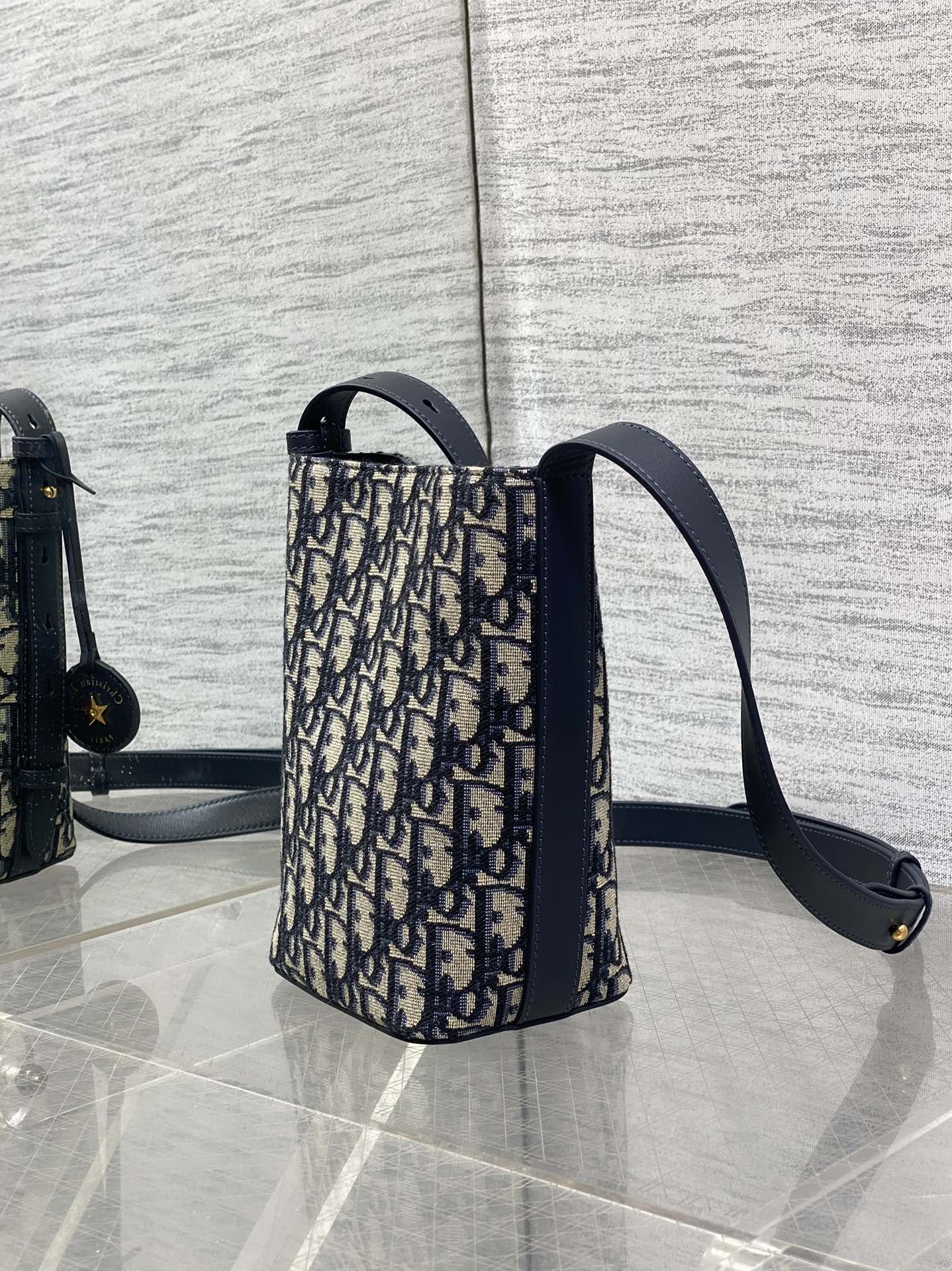 In Stock‼️ Dior's New Star Bucket Bag Collection The latest stunning handbags have arrived! Crafted from classic Oblique monogram fabric with exquisite workmanship, this adorable bucket bag design blends elegance with modern style. Its soft silhouette features a drawstring closure and removable long shoulder strap, combining practicality with beauty. Perfect for holiday outings—carry it with flair wherever you go! - Image 5