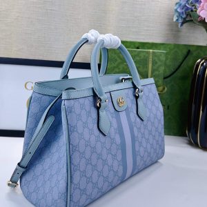 Alternative view of Batch 340... The new Ophidia collection presents striking silhouettes and functionality, expertly crafted in signature beige and brown colorways to create soft, refreshed bag designs.Beige and dark brown GG canvas Brown leather trim Light gold-tone hardware Green cotton lining Interior: One open pocket, one zippered pocket in the center compartment Handles (10 cm high) Removable and adjustable leather shoulder strap (Height: 50 cm to 55 cm;Length: 108 cm to 118 cm) Model: 836839 Dimensions: 33.5 cm (W) x 25 cm (H) x 14 cm (D) Weight: Approx. 0.95 kg Color: Sky Blue PVC Blue Leather. Made in Italy