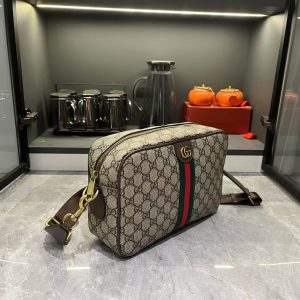 Alternative view of Batch 300...G G Ophidia Collection masterfully blends beige and brown tones, pairing classic silhouettes with innovative functionality in exceptionally soft fabrics. This crossbody bag features GG monogrammed coated fabric, adorned with double G insignia and woven strap details.Beige and dark brown GG interlocking pattern coated fabric, dark brown leather trim, gold-tone hardware, dark green linen-cotton blend lining. Model: 834468. Dimensions: 28.5 x 18 x 7.5 cm.