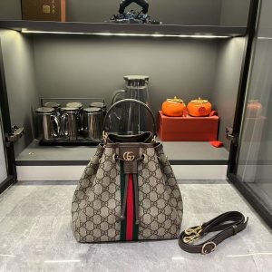 Batch 310...G G Ophidia collection masterfully reimagines innovative silhouettes and functionality, featuring signature beige and brown colorways to craft soft-textured, stylish handbag pieces.The flap features signature woven tape piping. Beige and dark brown GG monogram coated fabric with brown leather piping, light gold-tone hardware, and green linen-cotton blend lining. Model: 841313. Dimensions: 22x21.5x13cm.