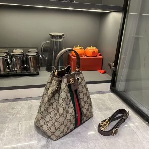 Alternative view of Batch 310...G G Ophidia collection masterfully reimagines innovative silhouettes and functionality, featuring signature beige and brown colorways to craft soft-textured, stylish handbag pieces.The flap features signature woven tape piping. Beige and dark brown GG monogram coated fabric with brown leather piping, light gold-tone hardware, and green linen-cotton blend lining. Model: 841313. Dimensions: 22x21.5x13cm.