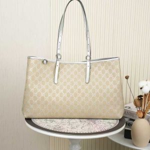 The GG Emblem collection reimagines the brand's enduring elegance and craftsmanship, featuring the iconic GG pattern in subtle tones that infuse freshness into the design.Signature beige and silver GG monogrammed coated fabric with silver leather trim, accented with contrasting stitching. Light gold-tone hardware. Webbing strap. Cotton lining. Bag shown sold separately; does not include bag charm.Includes D-ring for attaching removable accessories. Adjustable handle with eyelet (height: approx. 21.6 cm - approx. 31.5 cm). Interior: Two compartments and one central zippered compartment. Magnetic snap closure. Model: 815213.Dimensions: 38 cm (W) x 25 cm (H) x 15 cm (D) Weight: Approx. 0.85 kg Color: Apricot Silver/Natural Leather Made in Italy