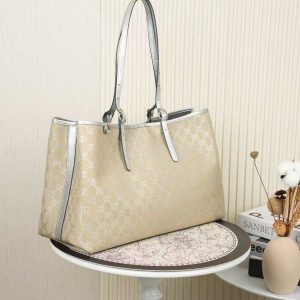 Alternative view of The GG Emblem collection reimagines the brand's enduring elegance and craftsmanship, featuring the iconic GG pattern in subtle tones that infuse freshness into the design.Signature beige and silver GG monogrammed coated fabric with silver leather trim, accented with contrasting stitching. Light gold-tone hardware. Webbing strap. Cotton lining. Bag shown sold separately; does not include bag charm.Includes D-ring for attaching removable accessories. Adjustable handle with eyelet (height: approx. 21.6 cm - approx. 31.5 cm). Interior: Two compartments and one central zippered compartment. Magnetic snap closure. Model: 815213.Dimensions: 38 cm (W) x 25 cm (H) x 15 cm (D) Weight: Approx. 0.85 kg Color: Apricot Silver/Natural Leather Made in Italy