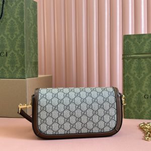 Alternative view of Batch 300...🔥🔥 Gucci Horsebit 1955 Shoulder Bag. Drawing inspiration from archival designs, the Gucci Horsebit 1955 collection masterfully blends classic details from the brand's founding over six decades ago with contemporary fashion sensibilities, highlighting the distinctive charm of the horsebit motif.This motif, rooted in the brand's equestrian heritage, features a double ring and elongated bar design, evolving into one of Gucci's most iconic and recognizable elements. Crafted in beige/ebony GG Supreme canvas with brown leather trim, gold-tone hardware, front horsebit detail, top handle, and metal chain shoulder strap. Model: 735178.Dimensions: 24*13*5cm. Color: Brown PVC