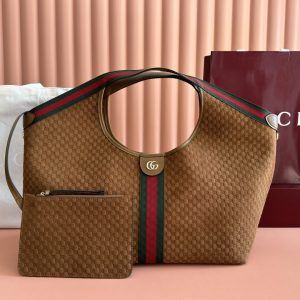 Lot 350...Gucci Giglio Series Large Tote Bag 853971 Product Details The Gucci Giglio collection debuted at the Florence 2026 Pre-Spring Fashion Show, paying homage to the brand's Italian heritage while blending timeless tradition with innovative spirit. This spacious tote is expertly crafted from GG canvas, adorned with woven ribbon piping, and includes a detachable clutch.Product Details · Off-white and dark brown GG canvas · Red and green woven ribbon trim · Green cotton lining · Double G logo · Includes detachable clutch Top handle: 18 cm height Magnetic snap closure 60 cm (W) x 47 cm (H) x 16 cm (D)
