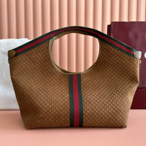 Alternative view of Lot 350...Gucci Giglio Series Large Tote Bag 853971 Product Details The Gucci Giglio collection debuted at the Florence 2026 Pre-Spring Fashion Show, paying homage to the brand's Italian heritage while blending timeless tradition with innovative spirit. This spacious tote is expertly crafted from GG canvas, adorned with woven ribbon piping, and includes a detachable clutch.Product Details · Off-white and dark brown GG canvas · Red and green woven ribbon trim · Green cotton lining · Double G logo · Includes detachable clutch Top handle: 18 cm height Magnetic snap closure 60 cm (W) x 47 cm (H) x 16 cm (D)