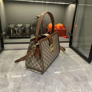 Alternative view of Batch 310... The GG Padlock series introduces a range of stylish bags with versatile carrying options, enhancing the 2025 Pre-Fall collection.This tote features a webbing lining reminiscent of the brand's signature motif. Light gold-tone hardware, red and green webbing cotton lining, removable and adjustable leather shoulder strap, padlock-style closure with leather keyring. Model: 838991. Dimensions: 31 x 21 x 11 cm.