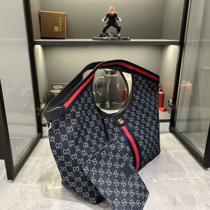 Alternative view of Lot 320...GG Giglio Oversized Tote, newly unveiled at the Florence 2026 Pre-Spring Fashion Show, pays homage to the brand's Italian heritage, blending timeless tradition with innovative spirit. This spacious tote is expertly crafted from GG canvas, adorned with woven ribbon piping, and includes a detachable clutch.Product Details · Off-white and dark brown GG canvas · Red and green woven ribbon piping · Green cotton lining · Double G logo · Includes detachable clutch · Magnetic snap closure Model: 853971 Dimensions: 60x47x16cm