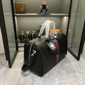 Alternative view of Batch 380... The G G Savoy collection masterfully blends beige and dark brown hues with a classic silhouette, crafted from exceptionally soft fabrics. This travel bag features GG monogrammed coated fabric, adorned with double G insignia and woven strap details.Beige and dark brown GG interlocking pattern coated fabric, dark brown leather piping, gold-tone hardware, green linen-cotton blend lining. Model: 834460. Dimensions: 44x 29x 25cm