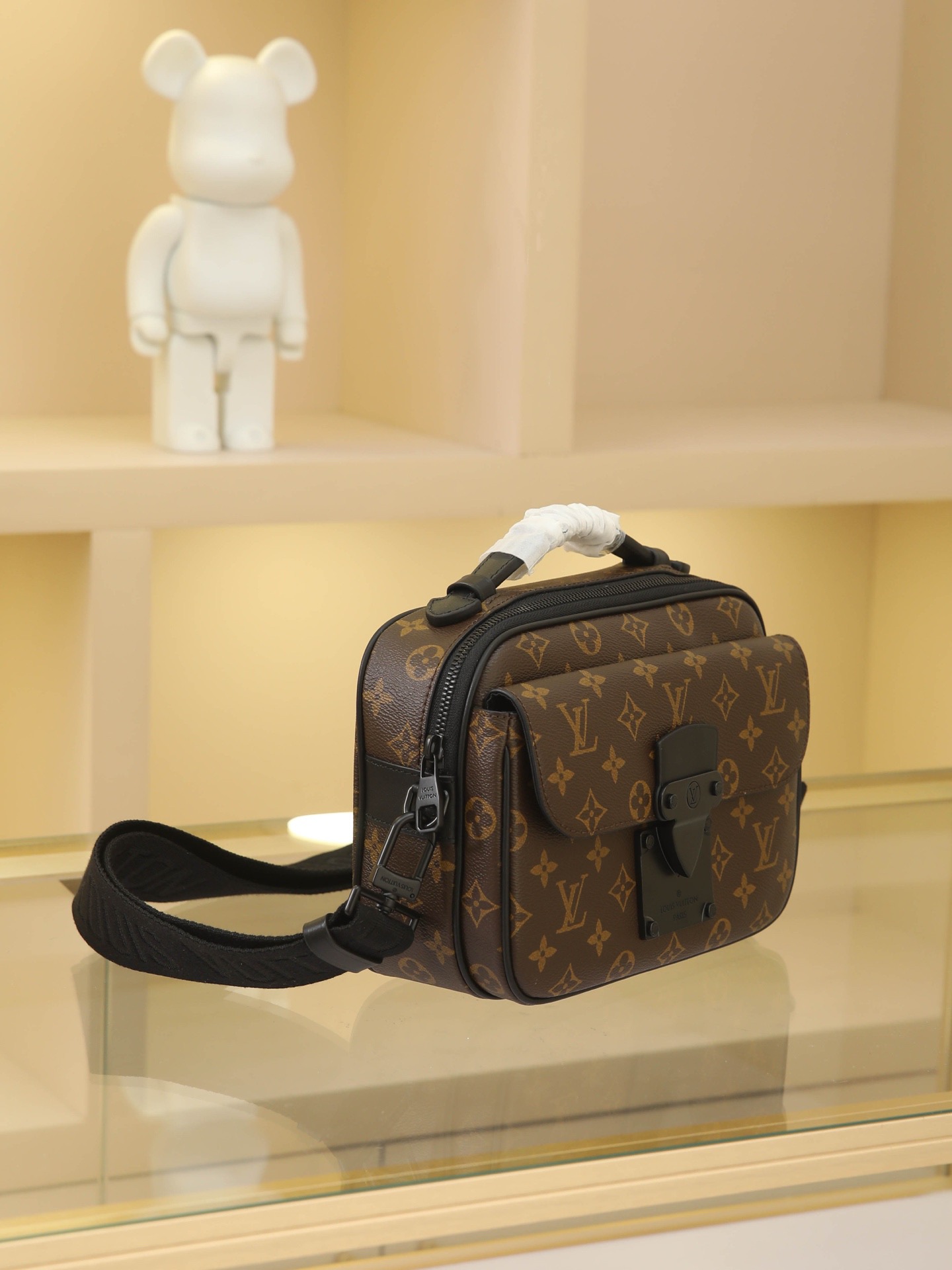 This S Lock messenger bag is crafted from Monogram Macassar canvas, featuring a new lock inspired by Georges Vuitton's 1886 trunk lock design. A special finishing process lends this magnetic metal lock a striking, modern look. It also includes a spacious zippered compartment, trunk-style leather handles, and an LV monogram shoulder strap, combining style with ease of use.Monogram Macassar coated canvas with Epi leather trim and matte black metal hardware lining - Leather handles with V-stitching and embossed logo - S-shaped magnetic clasp - Large front pocket - Large zippered compartment - Interior slip pocket - Detachable, adjustable shoulder strap!! Dimensions: 22x18x8CM - Image 2