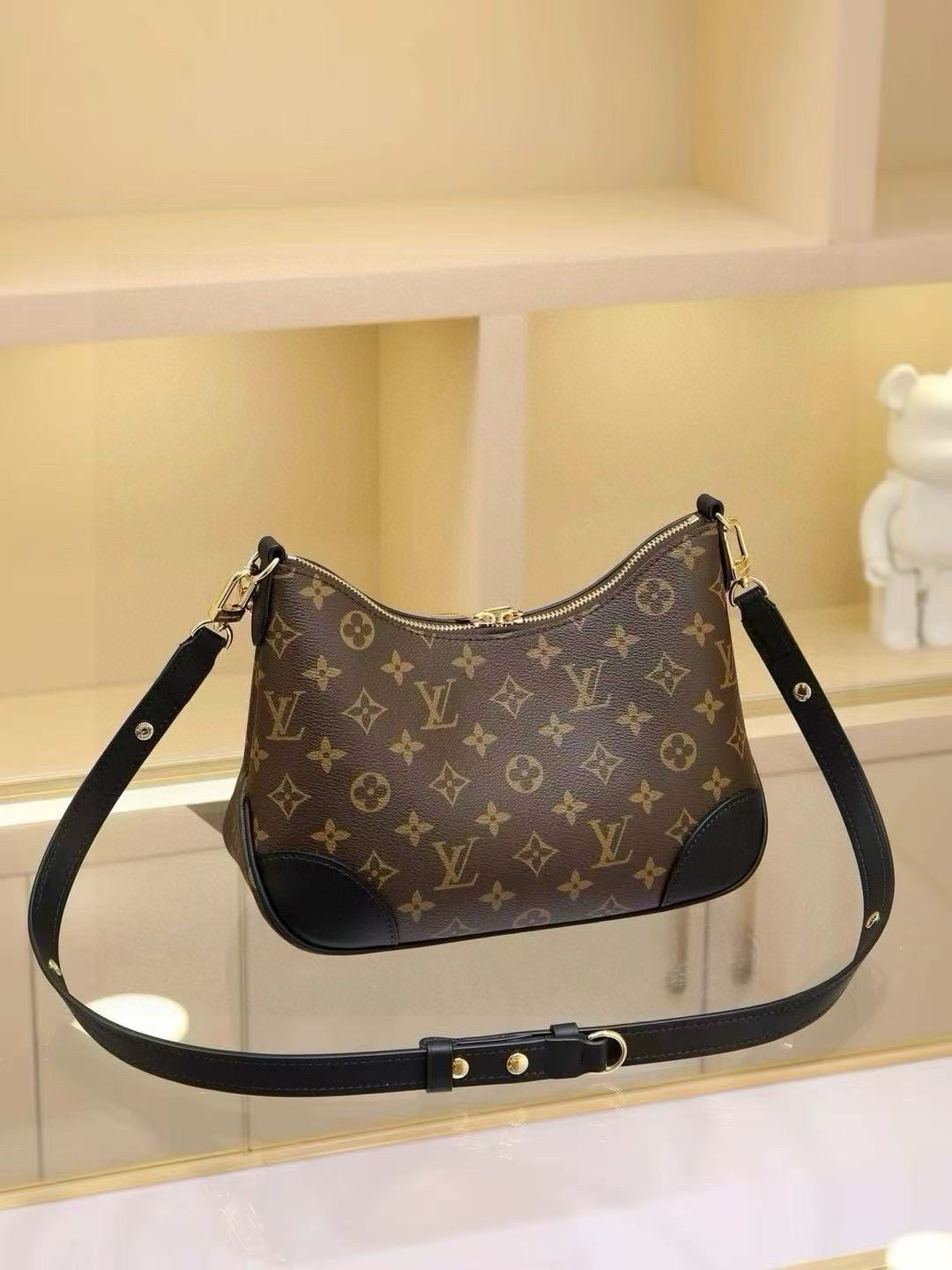 The compact handbag evokes vintage charm with Monogram canvas and reinforced leather trim. An adjustable strap allows for shoulder or crossbody carry, while a smooth zipper opening provides easy access to essentials. Dimensions: 27.0 x 16.0 x 10.0 cm - Image 9