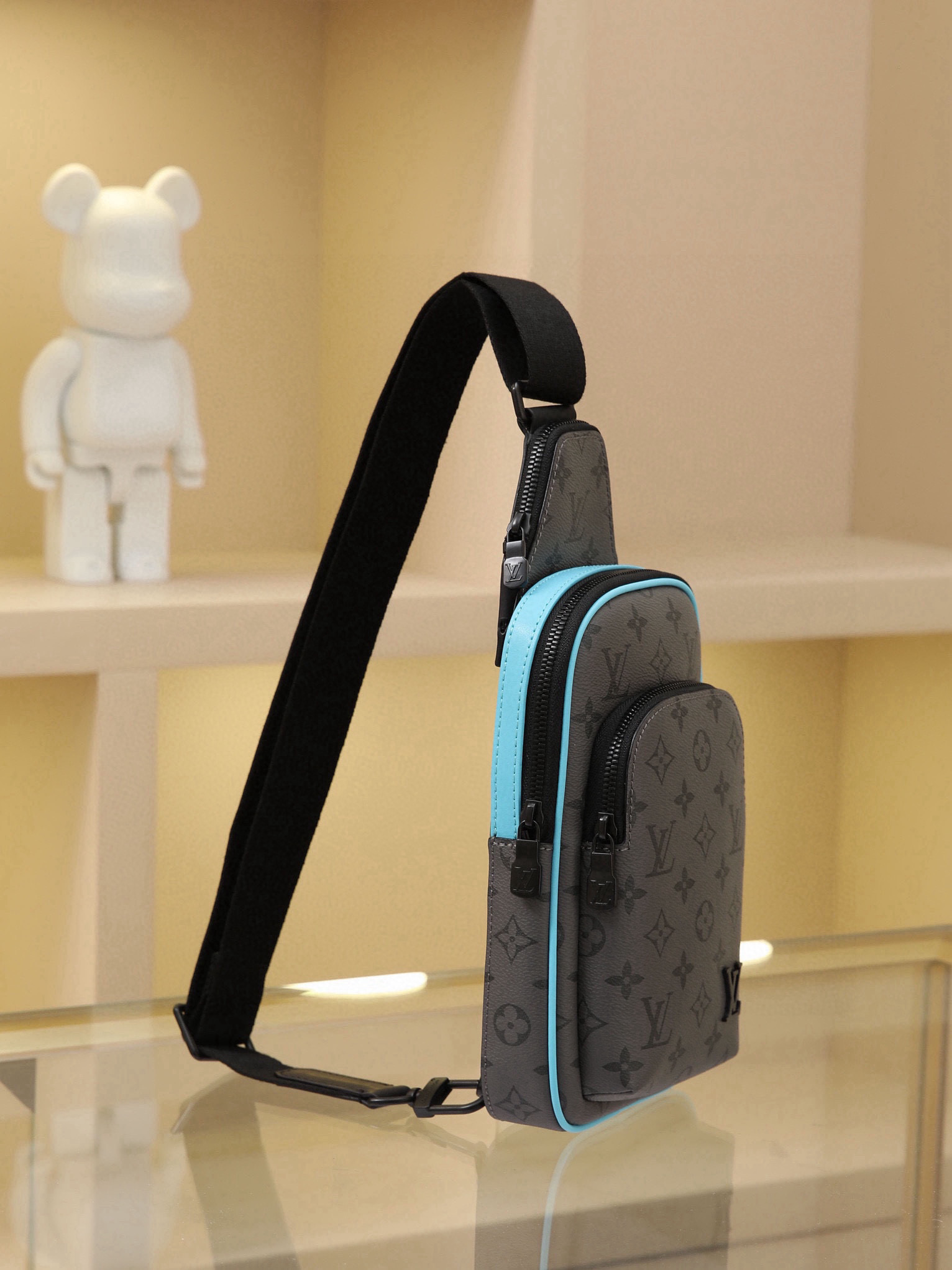 This Avenue mini shoulder bag features Monogram Eclipse coated canvas, exploring the trend of crossbody styling through its refined silhouette. The main compartment's interior pocket ensures secure storage, while the zippered exterior pocket offers easy access to everyday essentials. A triangular zippered pocket is positioned where the shoulder strap meets the bag. Dimensions: 16 × 33 × 5.7 cm - Image 2