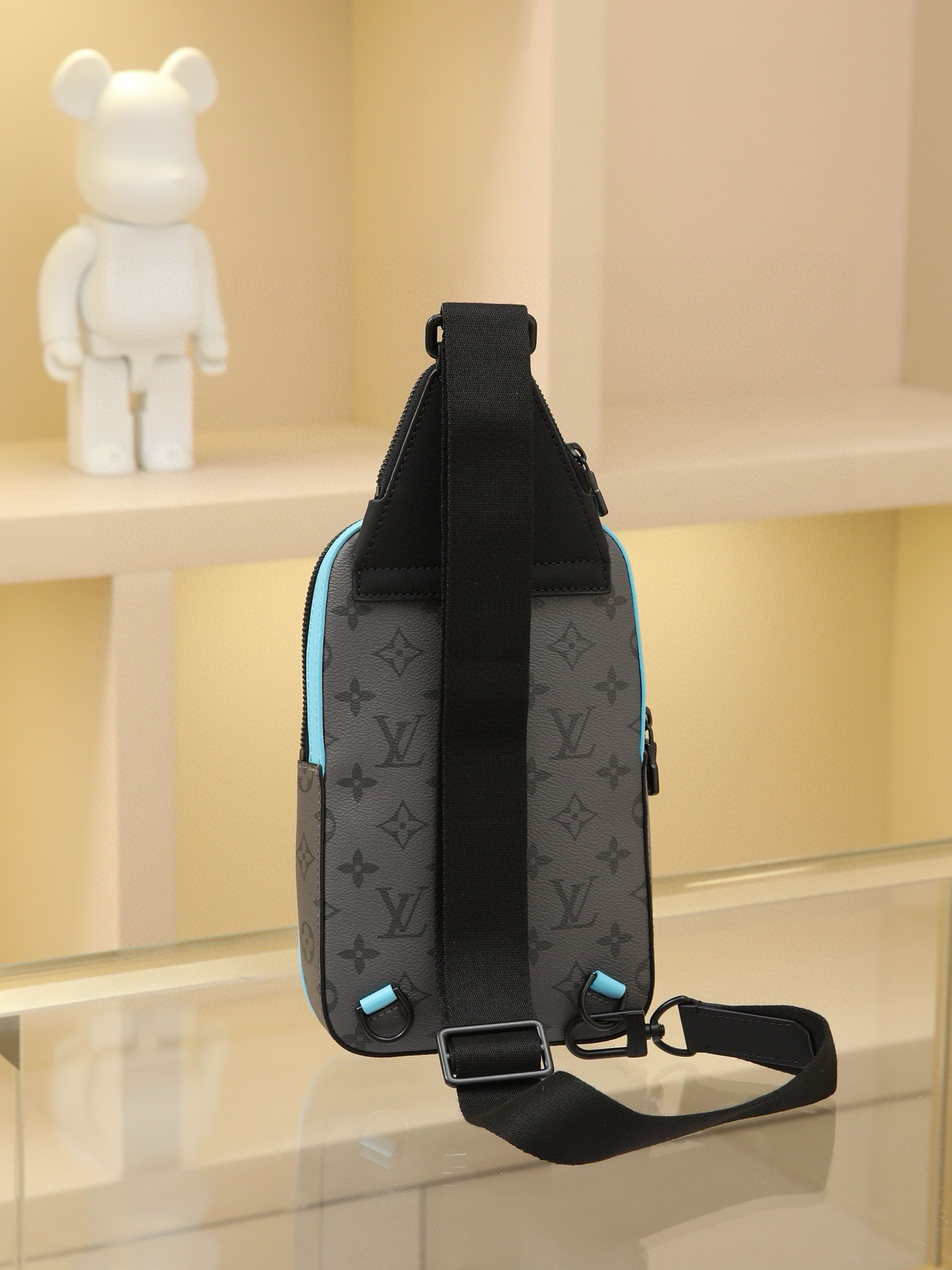 This Avenue mini shoulder bag features Monogram Eclipse coated canvas, exploring the trend of crossbody styling through its refined silhouette. The main compartment's interior pocket ensures secure storage, while the zippered exterior pocket offers easy access to everyday essentials. A triangular zippered pocket is positioned where the shoulder strap meets the bag. Dimensions: 16 × 33 × 5.7 cm - Image 3