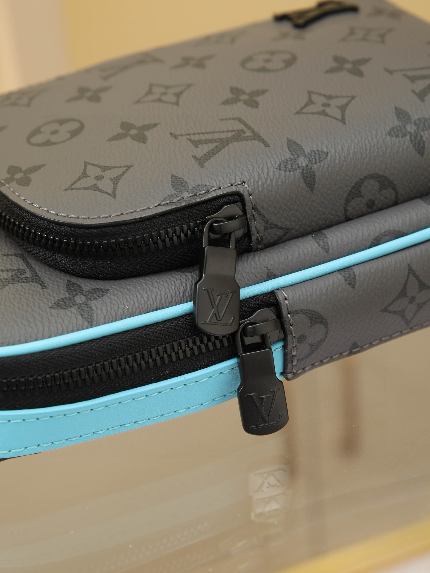 This Avenue mini shoulder bag features Monogram Eclipse coated canvas, exploring the trend of crossbody styling through its refined silhouette. The main compartment's interior pocket ensures secure storage, while the zippered exterior pocket offers easy access to everyday essentials. A triangular zippered pocket is positioned where the shoulder strap meets the bag. Dimensions: 16 × 33 × 5.7 cm - Image 6