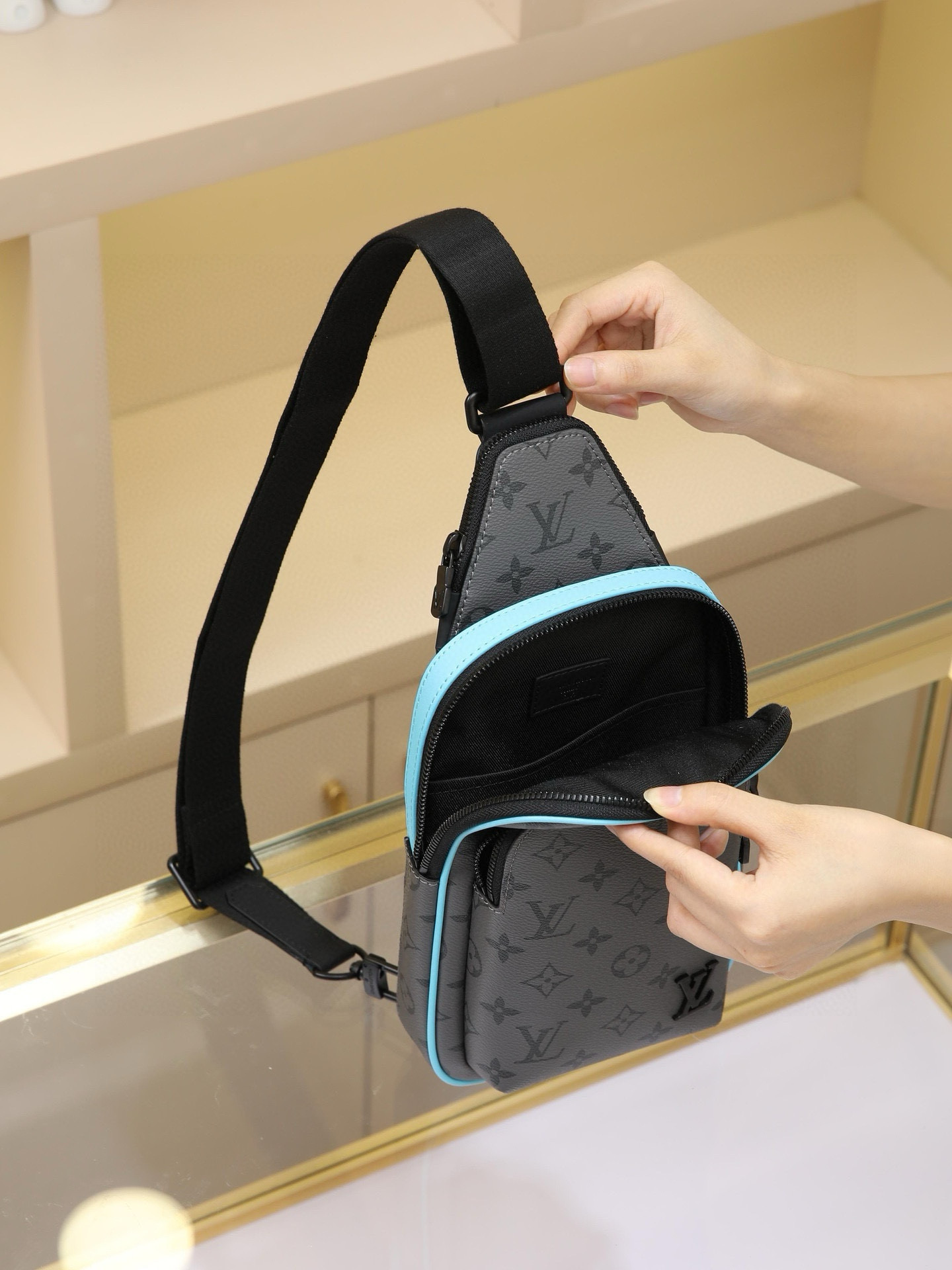 This Avenue mini shoulder bag features Monogram Eclipse coated canvas, exploring the trend of crossbody styling through its refined silhouette. The main compartment's interior pocket ensures secure storage, while the zippered exterior pocket offers easy access to everyday essentials. A triangular zippered pocket is positioned where the shoulder strap meets the bag. Dimensions: 16 × 33 × 5.7 cm - Image 8