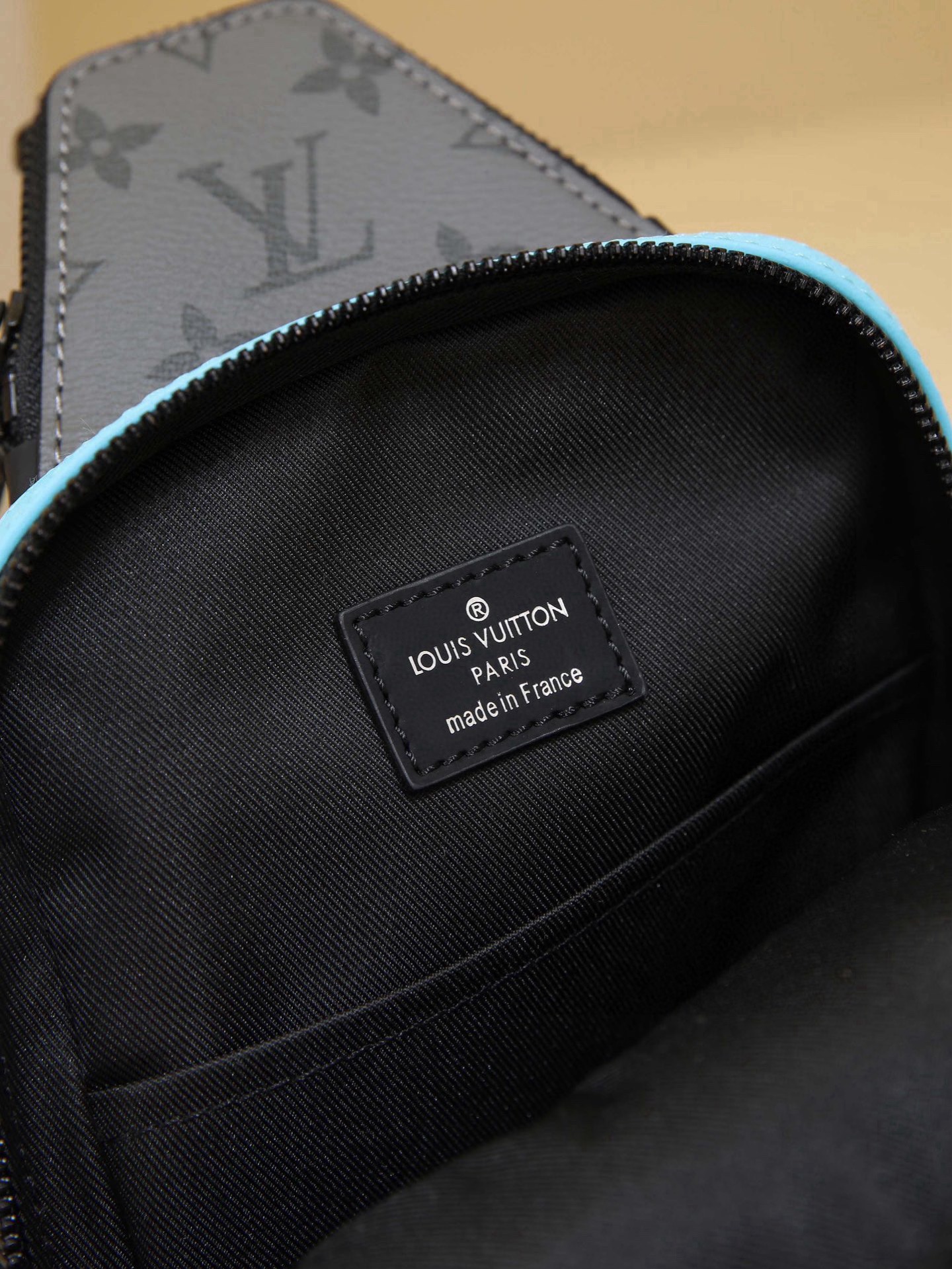 This Avenue mini shoulder bag features Monogram Eclipse coated canvas, exploring the trend of crossbody styling through its refined silhouette. The main compartment's interior pocket ensures secure storage, while the zippered exterior pocket offers easy access to everyday essentials. A triangular zippered pocket is positioned where the shoulder strap meets the bag. Dimensions: 16 × 33 × 5.7 cm - Image 9