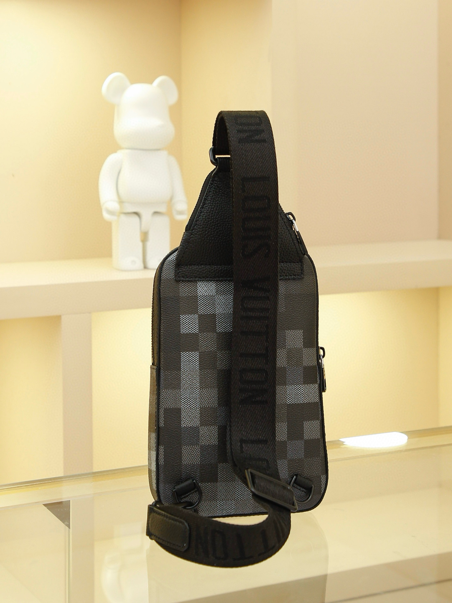 AVENUE Shoulder Bag crafted from Pharrell Williams' reimagined Damoflage Black coated canvas, blending the designer's avant-garde vision with the brand's heritage creativity. Features a pixelated camouflage-inspired Damier pattern and an "intelligent" shoulder strap designed for comfortable wear on either the left or right shoulder. Dimensions: 20x31x10cm - Image 3