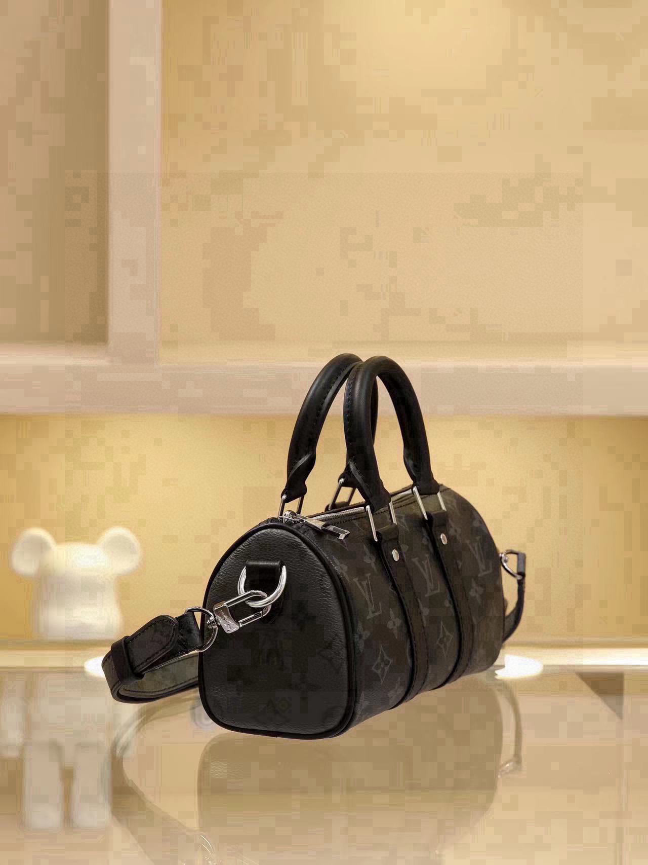 All-Steel Hardware Speedy Pillow Bag Collection This Keepall XS handbag is now available. Perfect for women, yet unisex in design. The black monogram pattern exudes sophistication. Most importantly, the shoulder strap is adjustable. Features: Monogram coated canvas, leather trims, fabric lining, zipper closure, removable and adjustable shoulder strap. Dimensions: 21 × 12 × 9 cm - Image 2