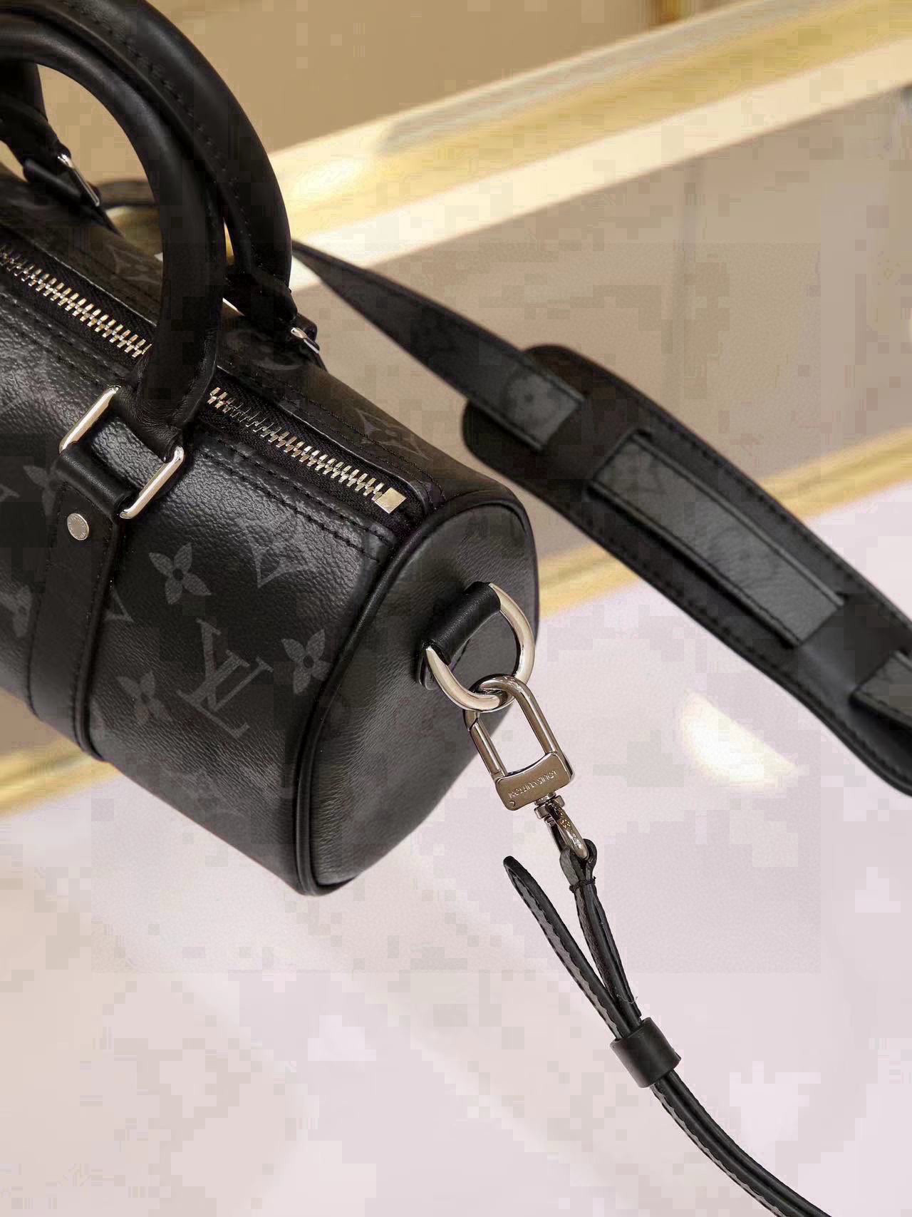 All-Steel Hardware Speedy Pillow Bag Collection This Keepall XS handbag is now available. Perfect for women, yet unisex in design. The black monogram pattern exudes sophistication. Most importantly, the shoulder strap is adjustable. Features: Monogram coated canvas, leather trims, fabric lining, zipper closure, removable and adjustable shoulder strap. Dimensions: 21 × 12 × 9 cm - Image 7