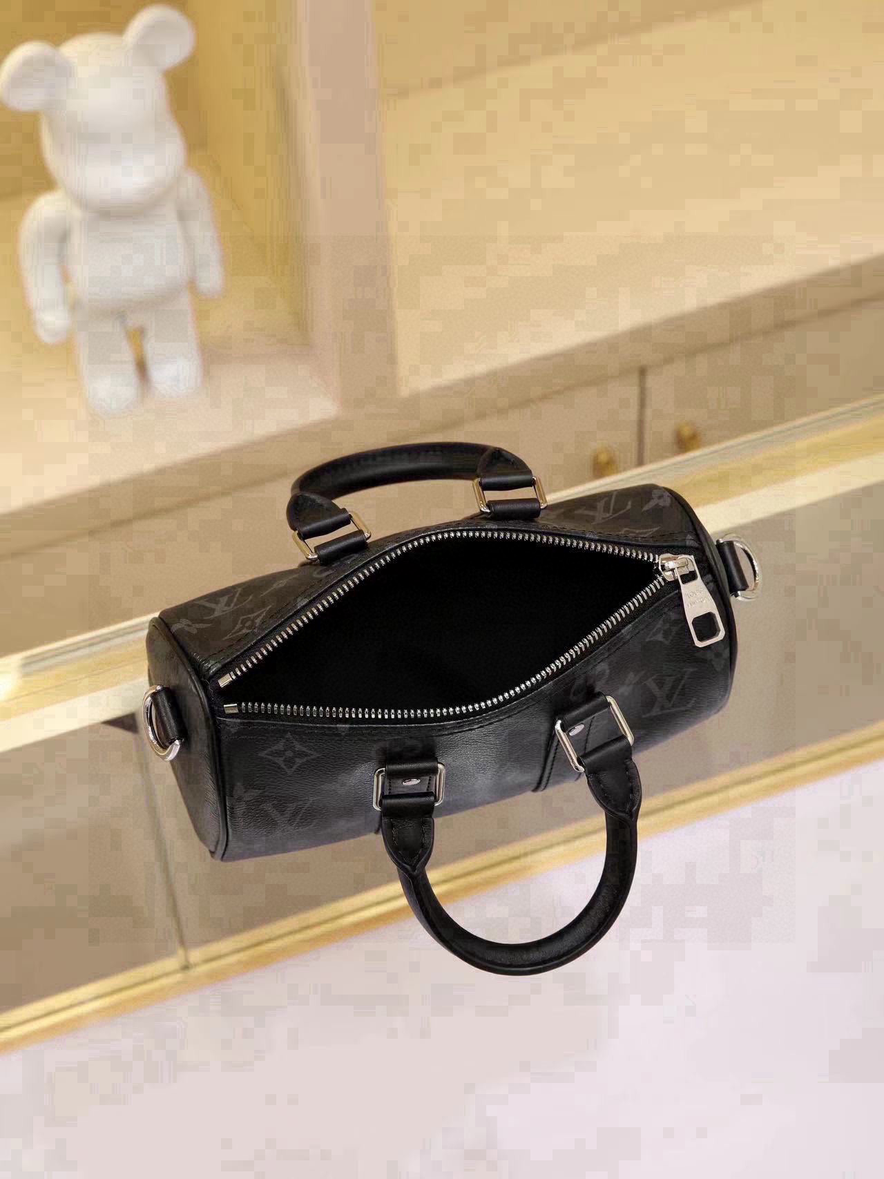 All-Steel Hardware Speedy Pillow Bag Collection This Keepall XS handbag is now available. Perfect for women, yet unisex in design. The black monogram pattern exudes sophistication. Most importantly, the shoulder strap is adjustable. Features: Monogram coated canvas, leather trims, fabric lining, zipper closure, removable and adjustable shoulder strap. Dimensions: 21 × 12 × 9 cm - Image 8