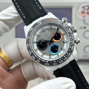 Alternative view of TW Factory Rolex Cosmograph Daytona Carbon Fiber Custom Edition. This timepiece offers lightweight comfort while maintaining a robust exterior. Each watch features a uniquely patterned carbon fiber material. 【Case】 Dimensions of 40x12.4mm perfectly match the original. TW Factory masterfully crafts the distinctive character of carbon fiber Rolex watches.Exclusively in the market, the entire case, bezel, and caseback are crafted from high-composite carbon fiber and ultra-bright luminous powder. Meticulous details are hand-finished with chamfered and polished edges, delivering exceptional texture. 【Bracelet Clasp】The strap features a hand-woven synthetic fiber band, offering breathable comfort and a soft texture. 【Movement】Equipped with the latest precise and mature Shanghai 4130 movement, it perfectly achieves powerful functionality—the ultimate value for money!!!