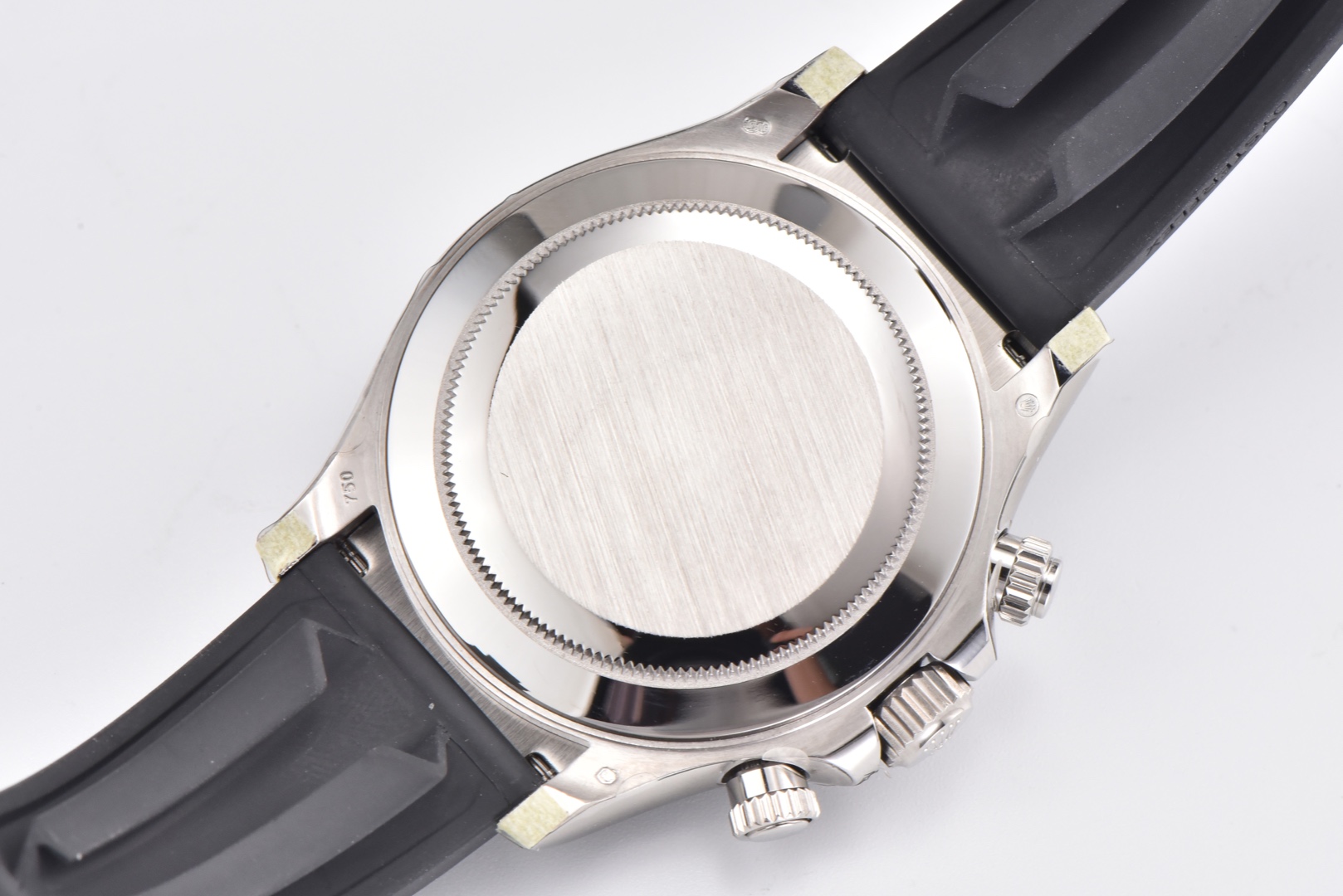 CLEAN Factory/C Factory Rolex 116519 Rubber Strap Daytona Key Features of This 116519 Natural Cloud Mother-of-Pearl Daytona: 1: Two identical mother-of-pearl Daytonas were purchased for molding. One was disassembled for reverse engineering, while the other served as a backup. The mother-of-pearl pattern requires meticulous selection due to high quality standards—many samples fail inspection.3: Fully upgraded hour markers. Flat surfaces are perfectly level, while side edges retain rounded corners—exactly matching the genuine article. 4: Glass considerations. The original glass isn't highly transparent, and its flat surface easily attracts fingerprints. Excessive transparency would look unnatural. We may eventually upgrade to high-transparency glass since customers prefer it—perhaps our last stubborn stand. 5: As a precious metal model, the case features 750/Saint Bernard dog head engravings on all four corners of the caseback. We spared no effort to replicate this detail. Detailed comparison images below show the resemblance. The only shortcoming is the tuft of fur atop the dog head, which remains technically unachievable—a minor flaw. 6: The lugs on both sides of the case are individually crafted. Compared to the standard 116500 steel case version, this is undoubtedly the most cost-intensive part—completely disassembled from the original and meticulously replicated 1:1. Perfectly interchangeable. 7: The strap uses C Factory straps. This is not a gimmick. Detailed comparison images are also provided below. 8: The strap buckle still uses an AR buckle. The opening/closing feel and details match the steel bracelet. C Factory works at a surprisingly slow pace, but we meticulously craft every accessory—never just copying official images. This release will only feature the cement gray colorway. Each subsequent color will include genuine vs. replica comparisons, reflecting our serious approach to the Daytona model.We ask for your patience. Every upcoming model will be a masterpiece, and our pricing may be slightly higher than competitors—a matter of personal perspective. May every watch enthusiast find their perfect timepiece, whether it bears the C Factory name or not. - Image 9